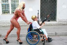 9791aeee8c57f8d451d2db7da2fb6db6-muscular-guy-in-drag-pushes-gun-toting-guy-in-wheelchair.jpg